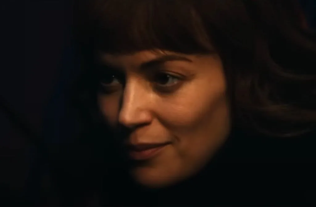Helly in the cabin with Mark in a scene from Severance episode 2x04. The dark and intimate setting reflects the growing tension between the characters.
