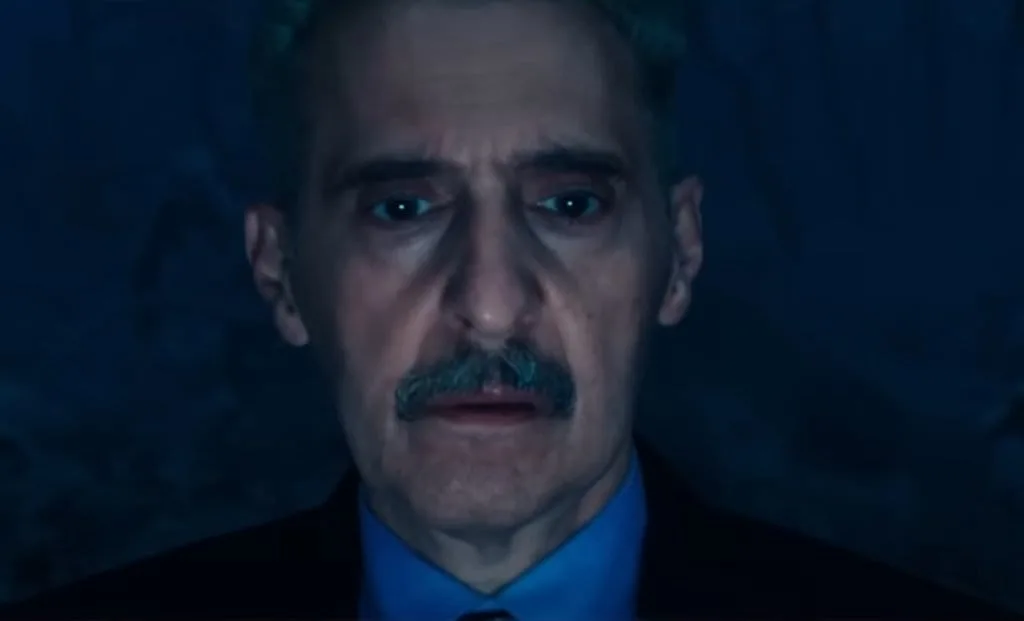 Irv in a moment of introspection in Severance episode 2x04. His expression indicates he is gathering his thoughts before taking action.