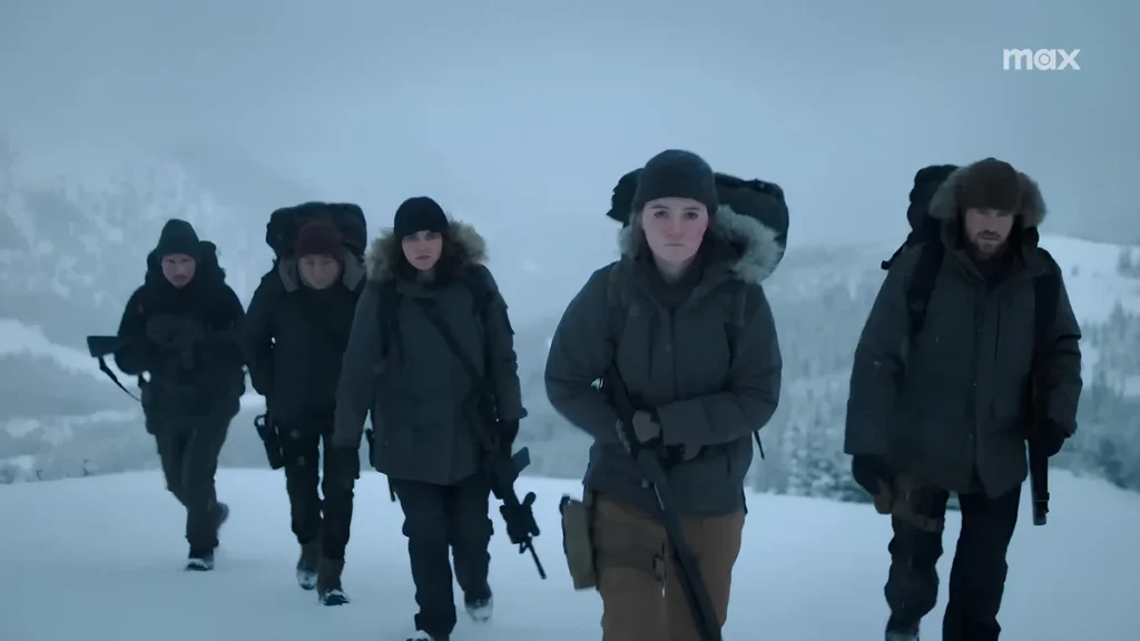 Armed group crossing a blizzard in The Last of Us Season 2, highlighting the struggle for survival amid the intense cold.