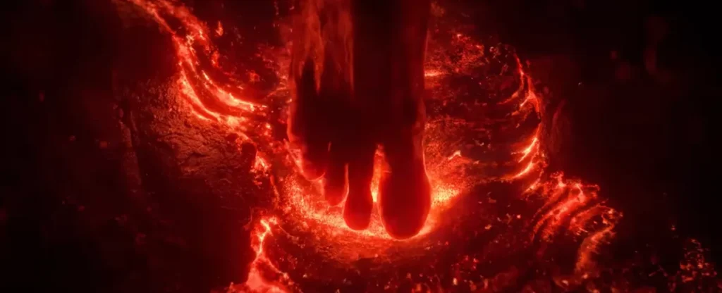 Pés de um Na'vi caminhando sobre lava incandescente, com o calor iluminando o ambiente em tons vermelhos.