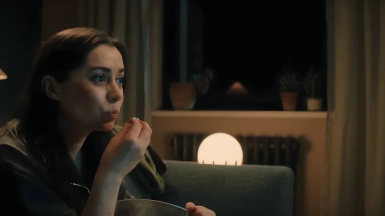 Nanette eating popcorn while contemplating her new future in USS Callister Infinity.