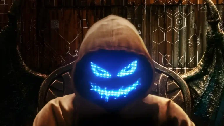 Imagem promocional da segunda temporada de O Jogo do Diabo chega já mostrando o personagem mascarado com expressão digital azul brilhante em um trono escuro e enigmático.