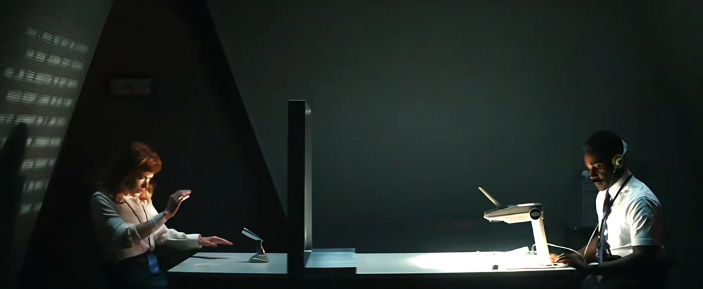 Scene from Severance shows Helly in the Break Room, being forced to repeat a sentence under supervision, symbolizing Lumon's psychological punishment.
