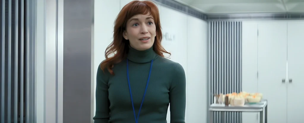 Scene from Severance where Helly looks visibly upset in Lumon's white hallways, expressing discomfort with the oppressive corporate environment.