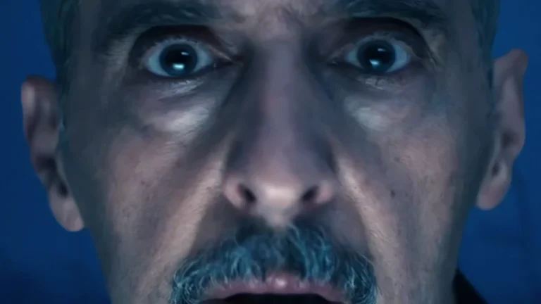 Close-up on Irving’s face, showing shock and disturbance at what he sees in the vision. Striking scene from Severance.