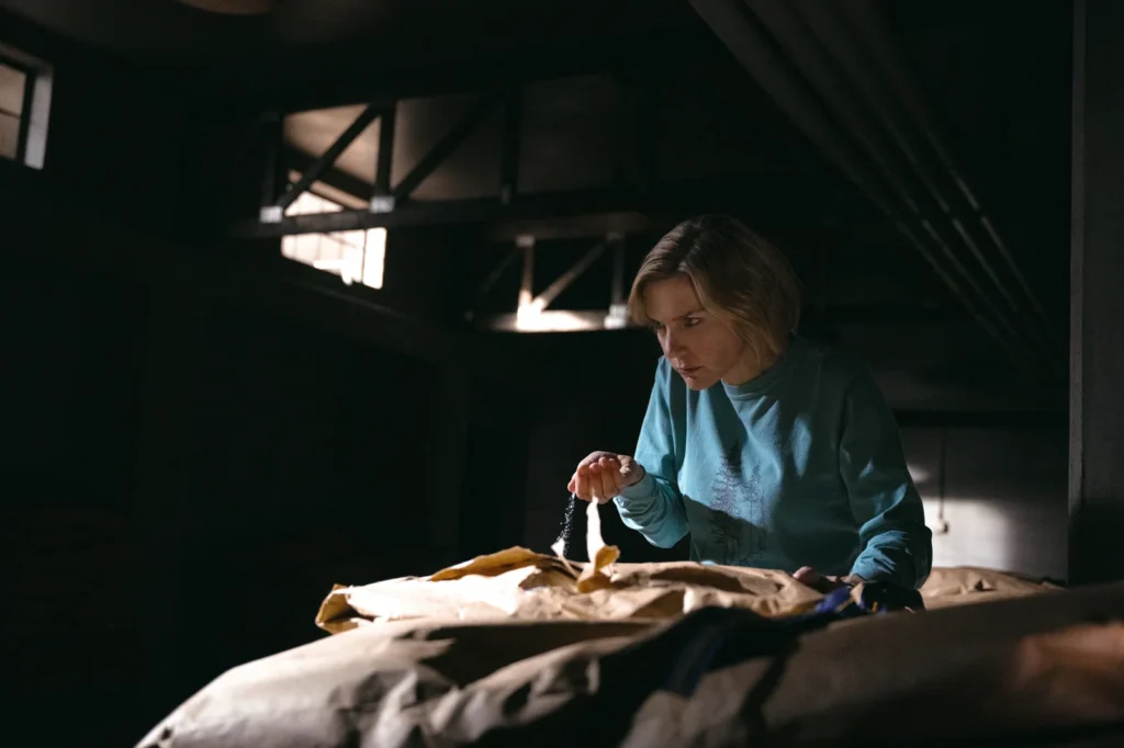 Carol observes the milk consumed by the infected in Pluribus, associated with protein derived from people who died after infection.